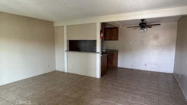 1735 E Washington St, Colton, CA 92324 - kitchen featuring ceiling fan, a textured ceiling, tile patterned floors, and open floor plan
