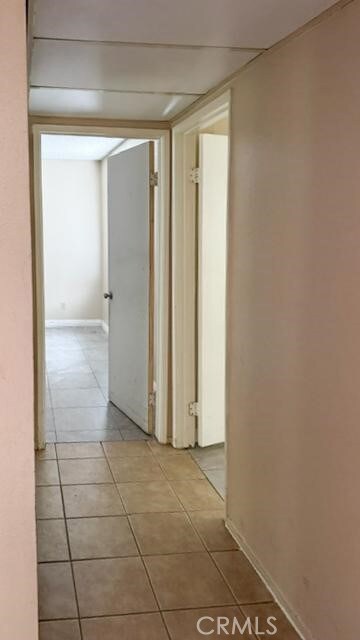 1735 E Washington St, Colton, CA 92324 - hall with tile patterned flooring and baseboards