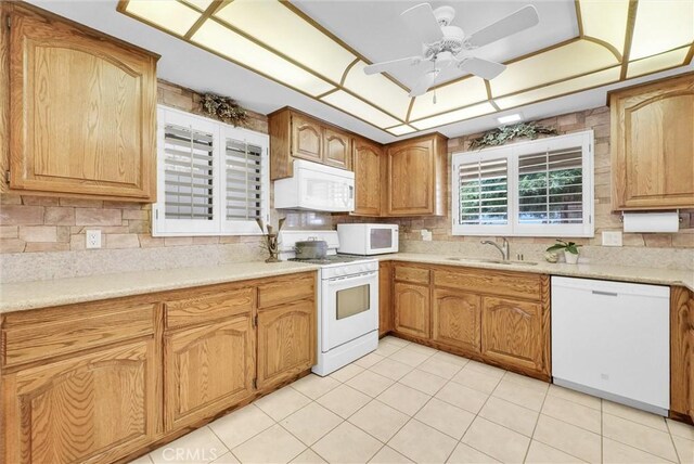25270 Tradewinds Dr, Menifee, CA 92585 - kitchen with white appliances, tasteful backsplash, and a ceiling fan