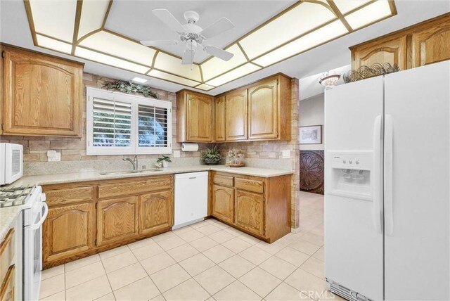 25270 Tradewinds Dr, Menifee, CA 92585 - kitchen with white appliances, ceiling fan, tasteful backsplash, and light countertops