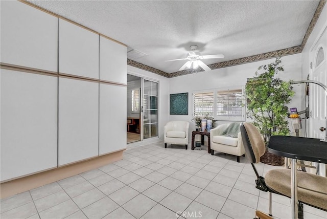 25270 Tradewinds Dr, Menifee, CA 92585 - living area featuring a ceiling fan, a textured ceiling, and light tile patterned floors