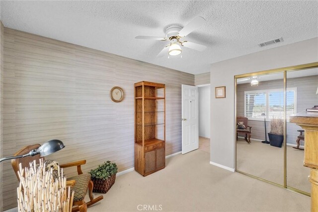 25270 Tradewinds Dr, Menifee, CA 92585 - living area with ceiling fan, light colored carpet, and a textured ceiling
