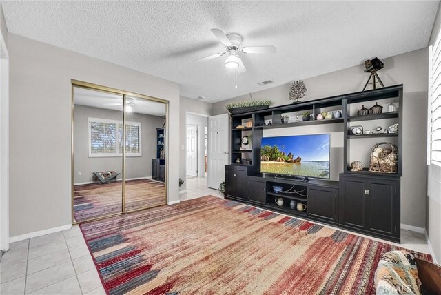 25270 Tradewinds Dr, Menifee, CA 92585 - living area with a ceiling fan, a textured ceiling, and light tile patterned flooring