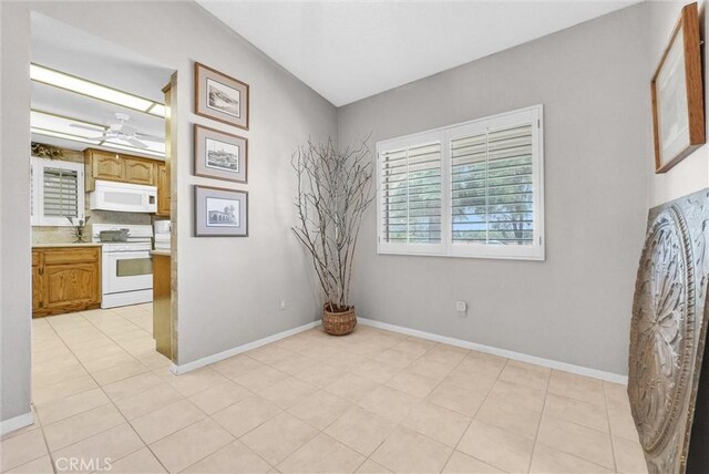 25270 Tradewinds Dr, Menifee, CA 92585 - spare room with baseboards and light tile patterned floors