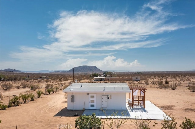 2250 Delgada Ave, Landers, CA 92285 - rear view of house with view of desert, a mountain view, a patio, and a view of countryside
