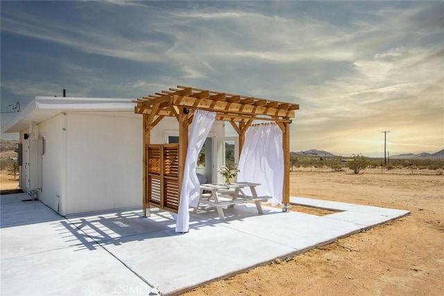 2250 Delgada Ave, Landers, CA 92285 - view of patio / terrace with a pergola and a mountain view
