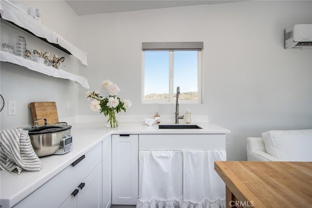 2250 Delgada Ave, Landers, CA 92285 - kitchen featuring open shelves, a wall mounted AC, white cabinetry, and butcher block countertops