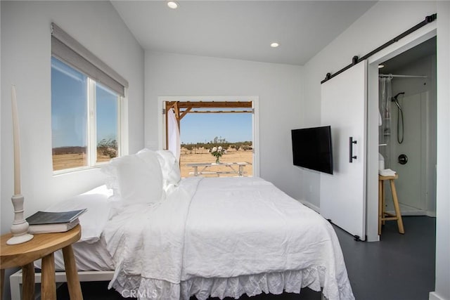 2250 Delgada Ave, Landers, CA 92285 - bedroom with multiple windows, a barn door, recessed lighting, and concrete floors