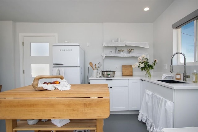 2250 Delgada Ave, Landers, CA 92285 - kitchen featuring freestanding refrigerator, white cabinets, recessed lighting, and open shelves