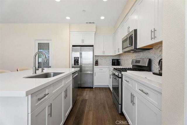 12178 Greenleaf Ln, Garden Grove, CA 92840 - kitchen with appliances with stainless steel finishes, white cabinets, decorative backsplash, dark wood-style flooring, and recessed lighting
