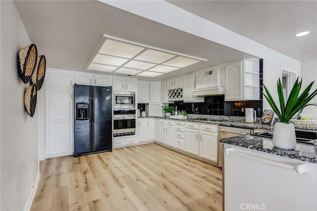 42768 Santa Suzanne Pl, Temecula, CA 92592 - kitchen featuring stainless steel appliances, premium range hood, dark stone counters, white cabinets, and recessed lighting