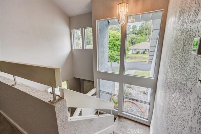 42768 Santa Suzanne Pl, Temecula, CA 92592 - staircase featuring a chandelier and a high ceiling