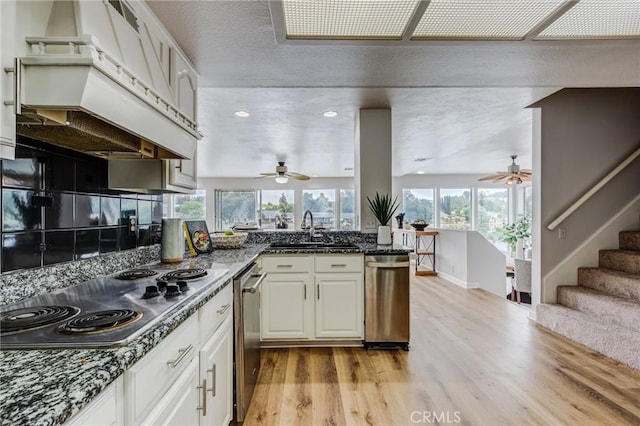 42768 Santa Suzanne Pl, Temecula, CA 92592 - kitchen featuring appliances with stainless steel finishes, a ceiling fan, light wood finished floors, custom range hood, and recessed lighting