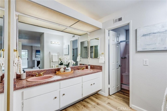 42768 Santa Suzanne Pl, Temecula, CA 92592 - bathroom featuring double vanity, wood finished floors, and a shower