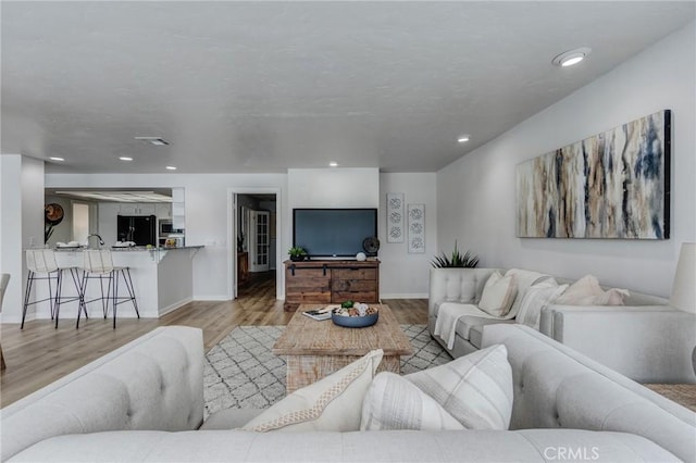 42768 Santa Suzanne Pl, Temecula, CA 92592 - living room featuring wood finished floors and recessed lighting