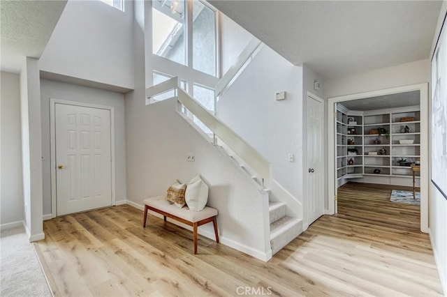 42768 Santa Suzanne Pl, Temecula, CA 92592 - staircase featuring wood finished floors and a towering ceiling