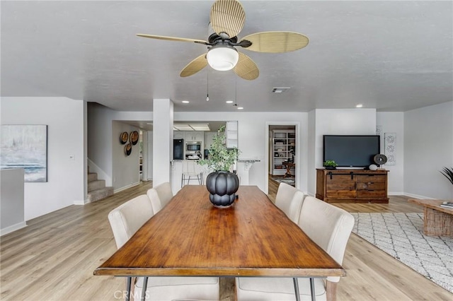 42768 Santa Suzanne Pl, Temecula, CA 92592 - dining space featuring stairway, light wood-style floors, and a ceiling fan