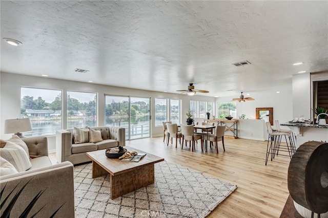42768 Santa Suzanne Pl, Temecula, CA 92592 - living area featuring light wood-type flooring, ceiling fan, a water view, and recessed lighting