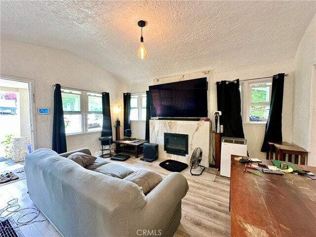 3238 Prospect Ave, La Crescenta, CA 91214 - living area with light wood finished floors, a textured ceiling, lofted ceiling, and a high end fireplace