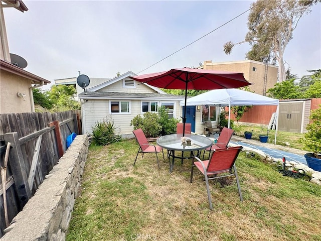 3238 Prospect Ave, La Crescenta, CA 91214 - fenced backyard featuring a storage unit, outdoor dining area, and a patio area