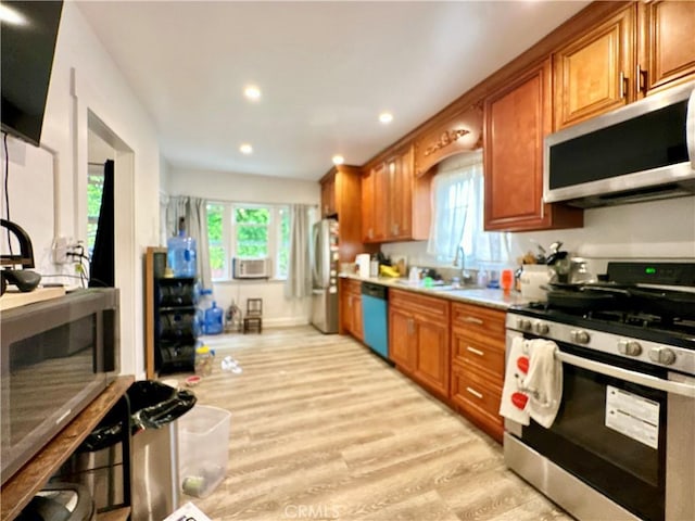 3238 Prospect Ave, La Crescenta, CA 91214 - kitchen with stainless steel appliances, brown cabinetry, light wood-style flooring, light countertops, and recessed lighting