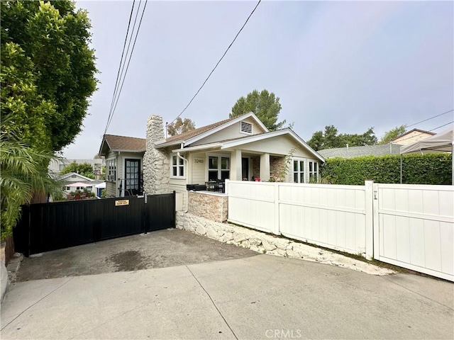 3238 Prospect Ave, La Crescenta, CA 91214 - bungalow-style home featuring a gate, stone siding, and a chimney