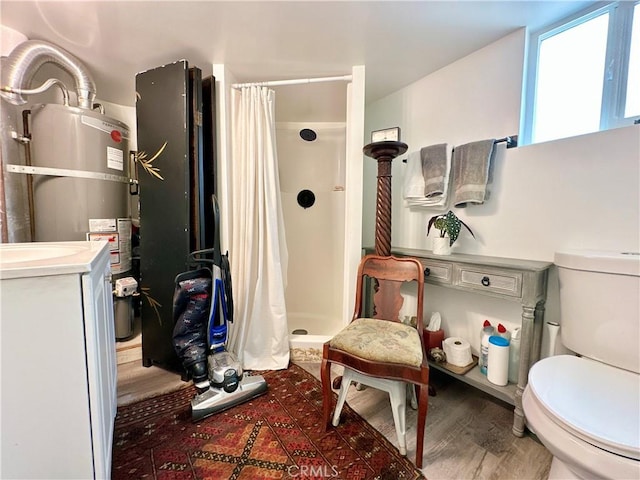 3238 Prospect Ave, La Crescenta, CA 91214 - full bathroom with secured water heater, a shower stall, wood finished floors, and vanity