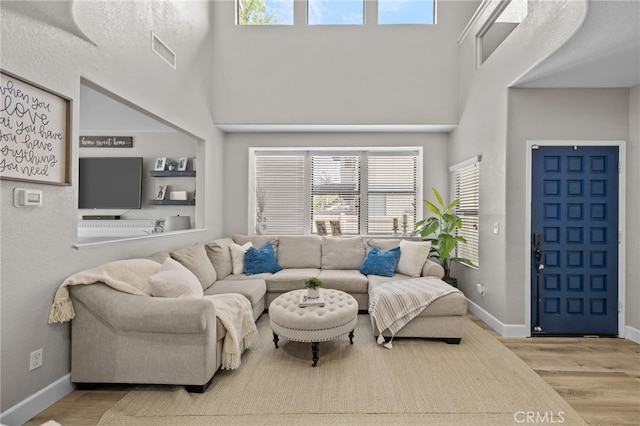 1519 San Rafael Pl, Corona, CA 92882 - living room featuring wood finished floors, healthy amount of natural light, and a towering ceiling