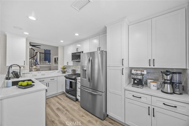1519 San Rafael Pl, Corona, CA 92882 - kitchen with stainless steel appliances, backsplash, white cabinets, ceiling fan, and recessed lighting