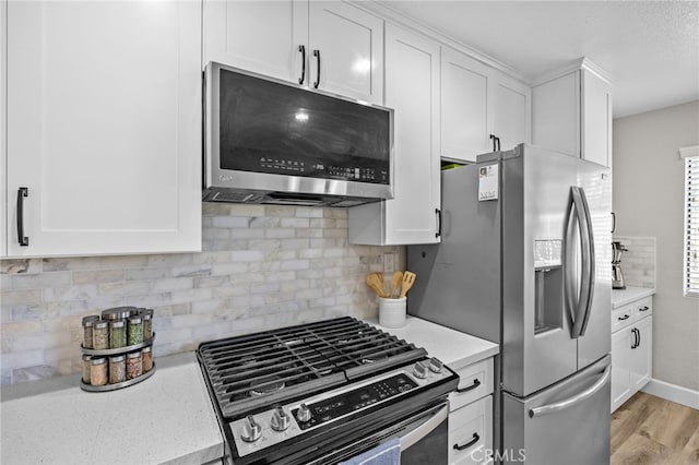 1519 San Rafael Pl, Corona, CA 92882 - kitchen with appliances with stainless steel finishes, white cabinets, decorative backsplash, light wood finished floors, and light stone counters