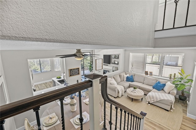 1519 San Rafael Pl, Corona, CA 92882 - living room featuring a textured ceiling, vaulted ceiling, a ceiling fan, and light wood-style flooring