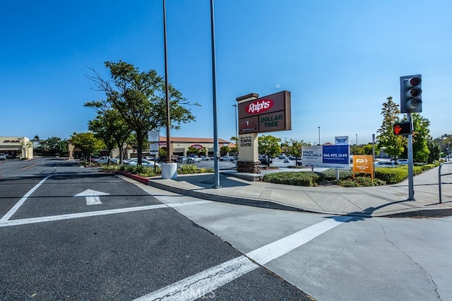 1519 San Rafael Pl, Corona, CA 92882 - view of asphalt road featuring traffic lights, curbs, and sidewalks