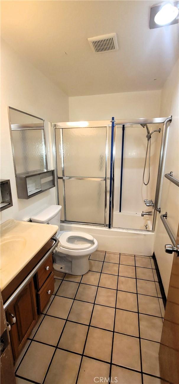 14805 Chase St Unit 105, Panorama City, CA 91402 - bathroom with vanity, tile patterned floors, and enclosed tub / shower combo