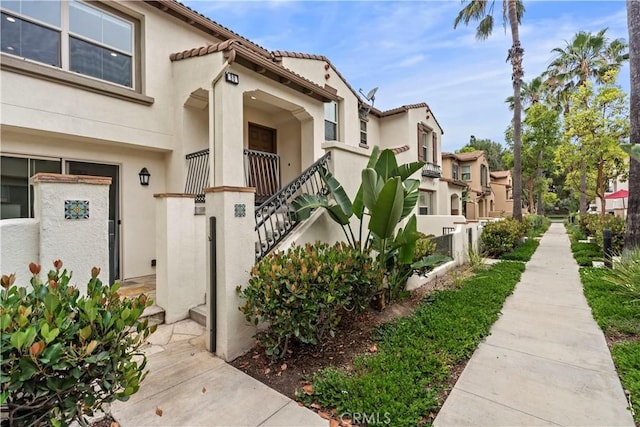 80 Hedge Bloom, Irvine, CA 92618 - doorway to property featuring stucco siding and a residential view