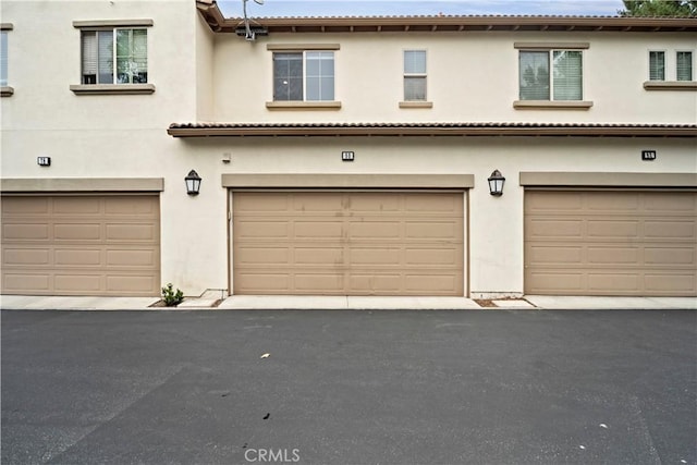 80 Hedge Bloom, Irvine, CA 92618 - view of front of property featuring a garage and stucco siding