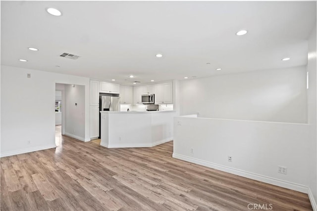 80 Hedge Bloom, Irvine, CA 92618 - unfurnished living room featuring light wood-type flooring and recessed lighting