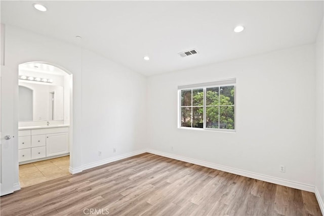 80 Hedge Bloom, Irvine, CA 92618 - unfurnished bedroom featuring light wood-style floors, recessed lighting, and ensuite bath
