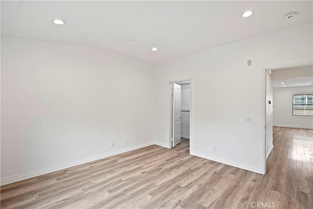 80 Hedge Bloom, Irvine, CA 92618 - unfurnished bedroom with light wood finished floors, recessed lighting, and a walk in closet