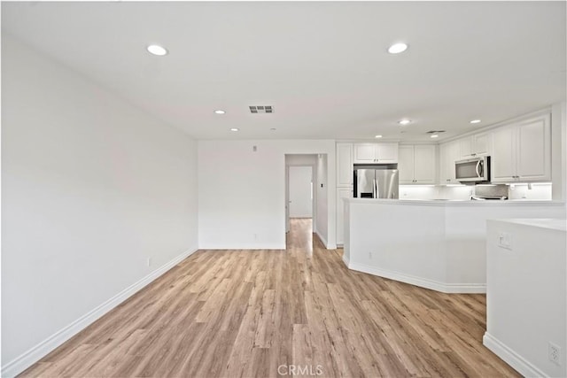 80 Hedge Bloom, Irvine, CA 92618 - unfurnished living room featuring light wood finished floors and recessed lighting