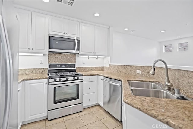 80 Hedge Bloom, Irvine, CA 92618 - kitchen featuring stainless steel appliances, white cabinets, light tile patterned floors, and recessed lighting