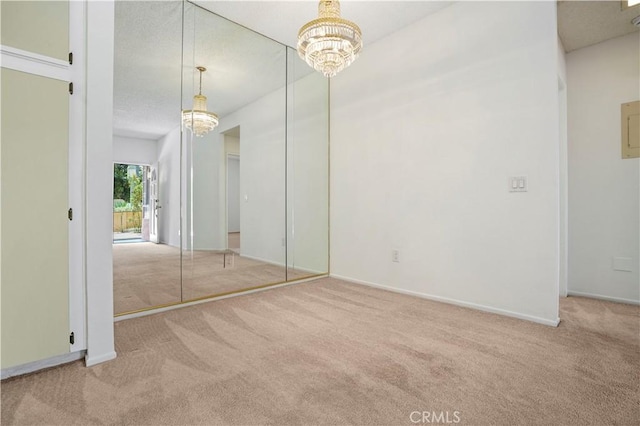 33 Abrazo Aisle Unit 174, Irvine, CA 92614 - unfurnished bedroom featuring a chandelier, carpet flooring, and a textured ceiling
