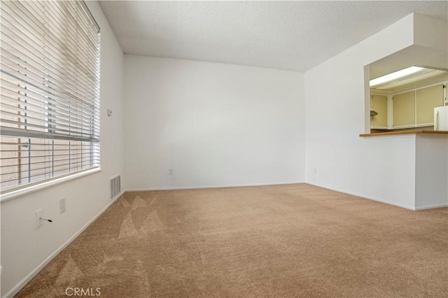 33 Abrazo Aisle Unit 174, Irvine, CA 92614 - unfurnished living room featuring carpet and a textured ceiling