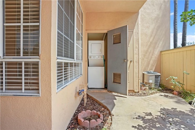 33 Abrazo Aisle Unit 174, Irvine, CA 92614 - view of exterior entry featuring stacked washer and clothes dryer and stucco siding