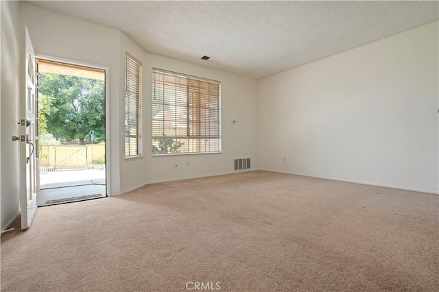 33 Abrazo Aisle Unit 174, Irvine, CA 92614 - unfurnished room with light carpet and a textured ceiling