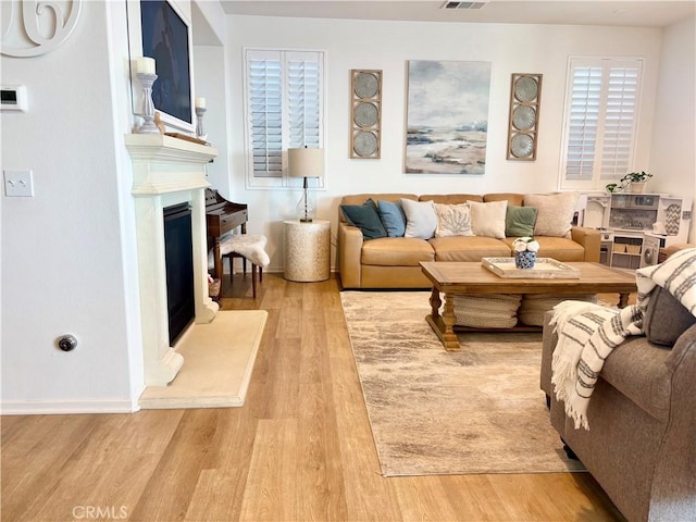 281 Singleton Canyon Rd, Calimesa, CA 92320 - living area with light wood-style floors and a fireplace with raised hearth