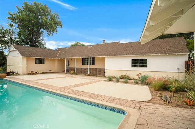 17450 Devonshire St, Northridge, CA 91325 - rear view of house featuring an outdoor pool, a patio, a shingled roof, and brick siding