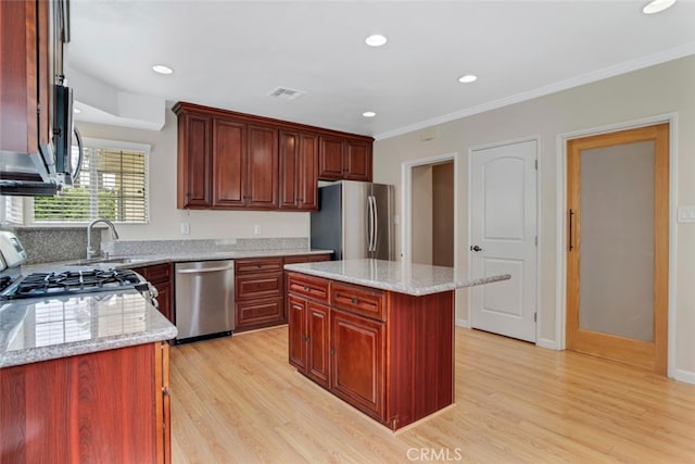 17450 Devonshire St, Northridge, CA 91325 - kitchen featuring appliances with stainless steel finishes, light wood finished floors, crown molding, recessed lighting, and light stone counters