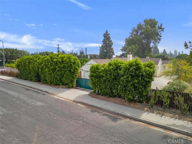 17450 Devonshire St, Northridge, CA 91325 - view of asphalt street featuring sidewalks, curbs, and street lights
