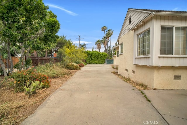 17450 Devonshire St, Northridge, CA 91325 - view of side of property featuring board and batten siding and concrete driveway