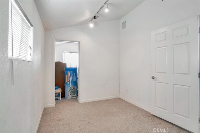 17450 Devonshire St, Northridge, CA 91325 - empty room featuring rail lighting, carpet flooring, and vaulted ceiling